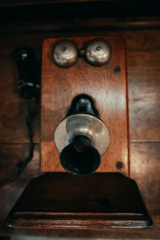 an old style phone on a wooden table