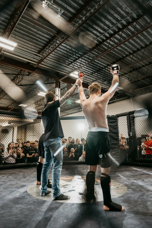 two men holding bottles of wine in the air