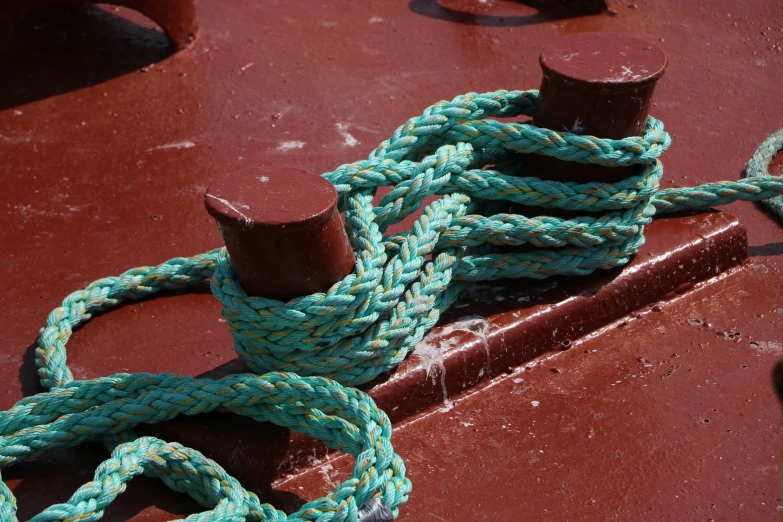 rope wrapped around metal hook on a boat