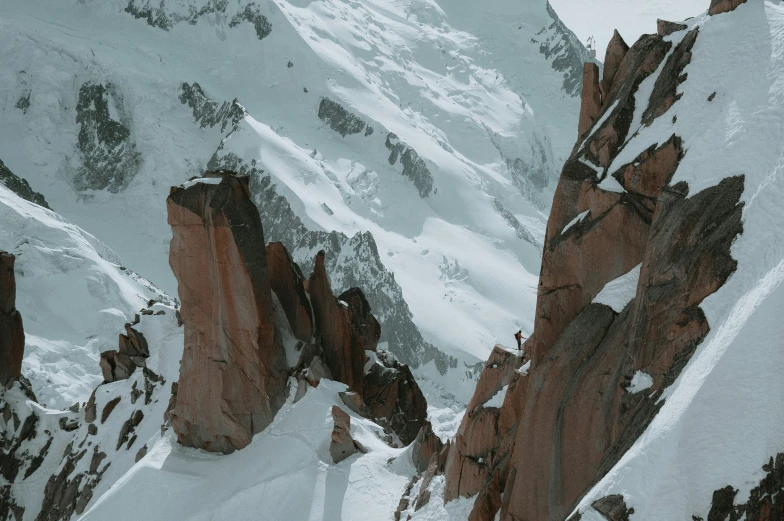 a po looking down at an enormous cliff and snow