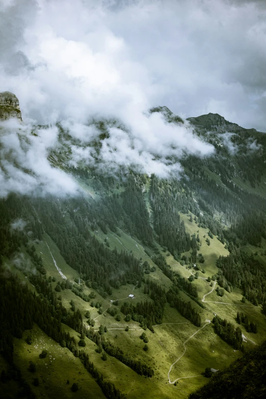 a view looking down into the valley from atop a mountain