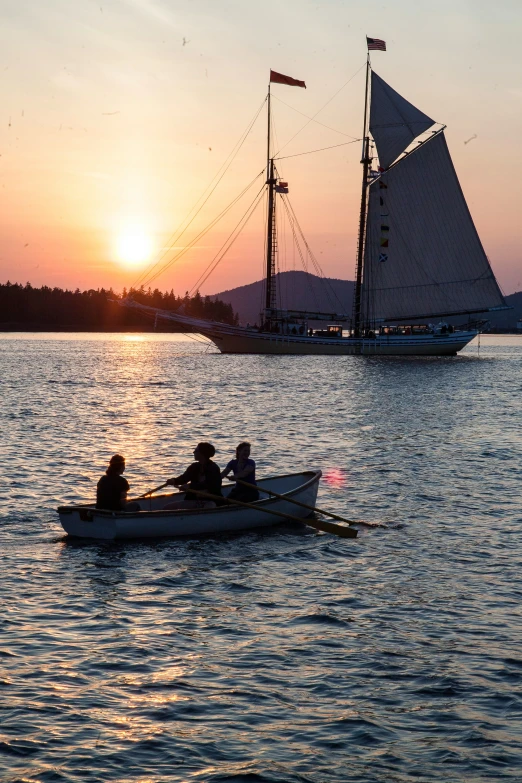 people are in a boat sailing on the water