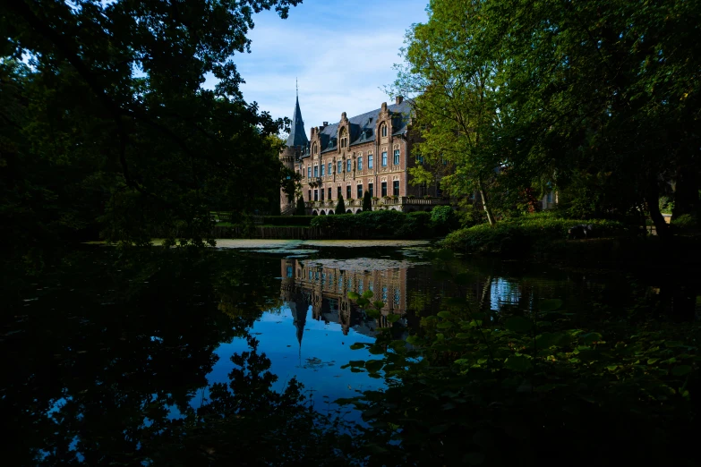 a large stone building reflecting in the water