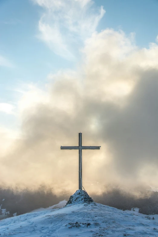 a large wooden cross on a mountain top