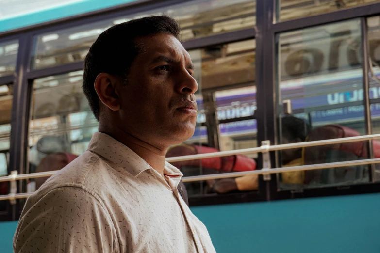 a man standing outside by the side of a bus