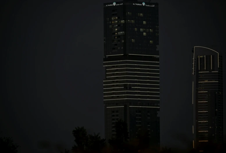 tall buildings lit up with lights at night