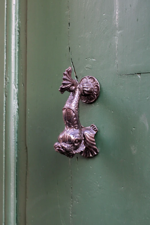 a decorative door handle in the shape of a fish