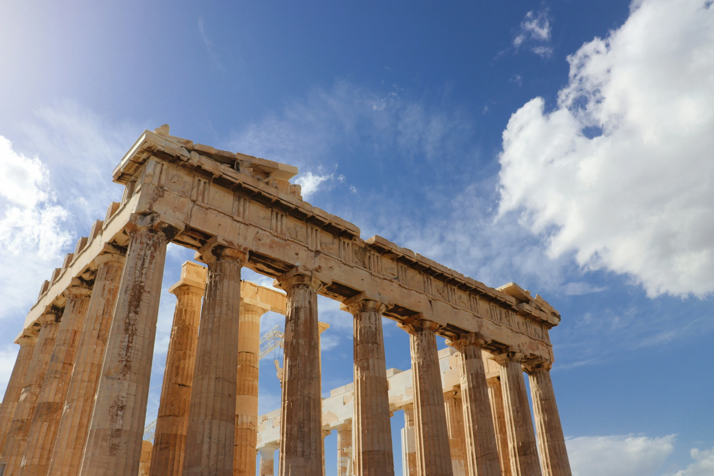 a row of different pillars under a blue sky