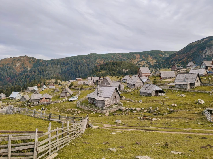 an old, rundown village sits on a hillside overlooking a valley