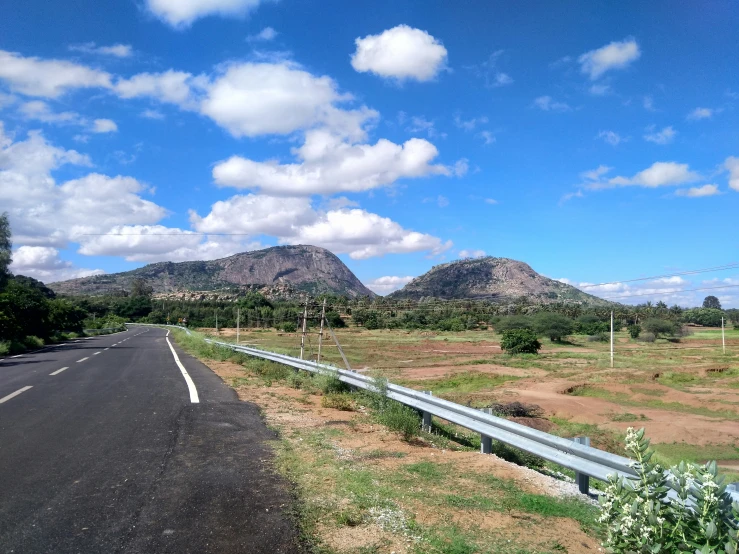 a highway with mountains in the distance behind it