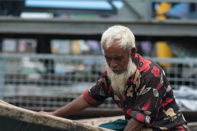 an old man is sitting on a boat