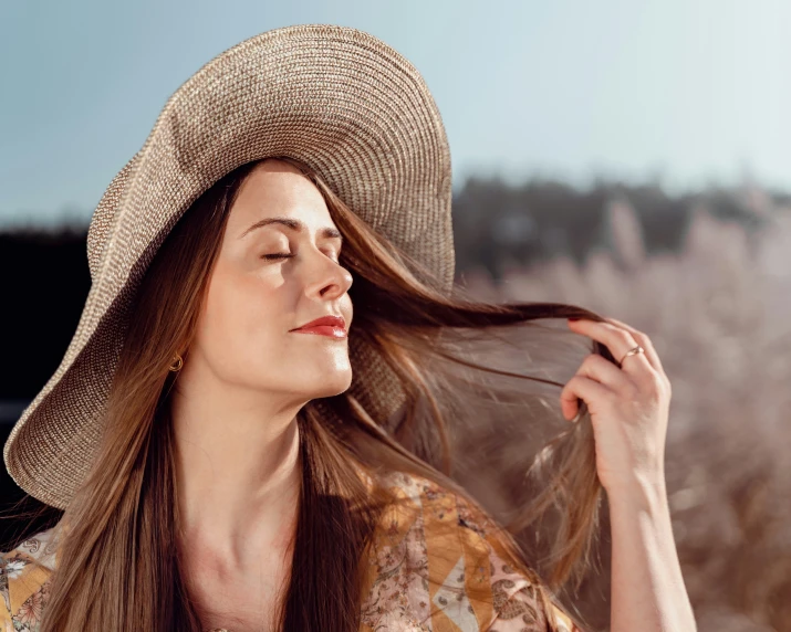 a beautiful young woman with long hair in a flowered shirt