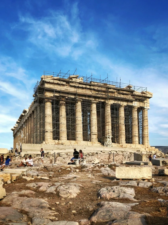 tourists standing on the ruins of a ruined temple