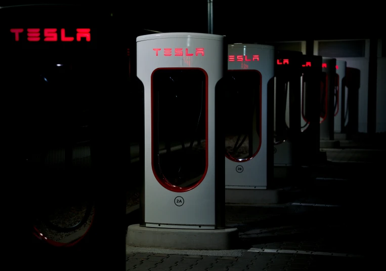 a row of parking meters lit up by red lights