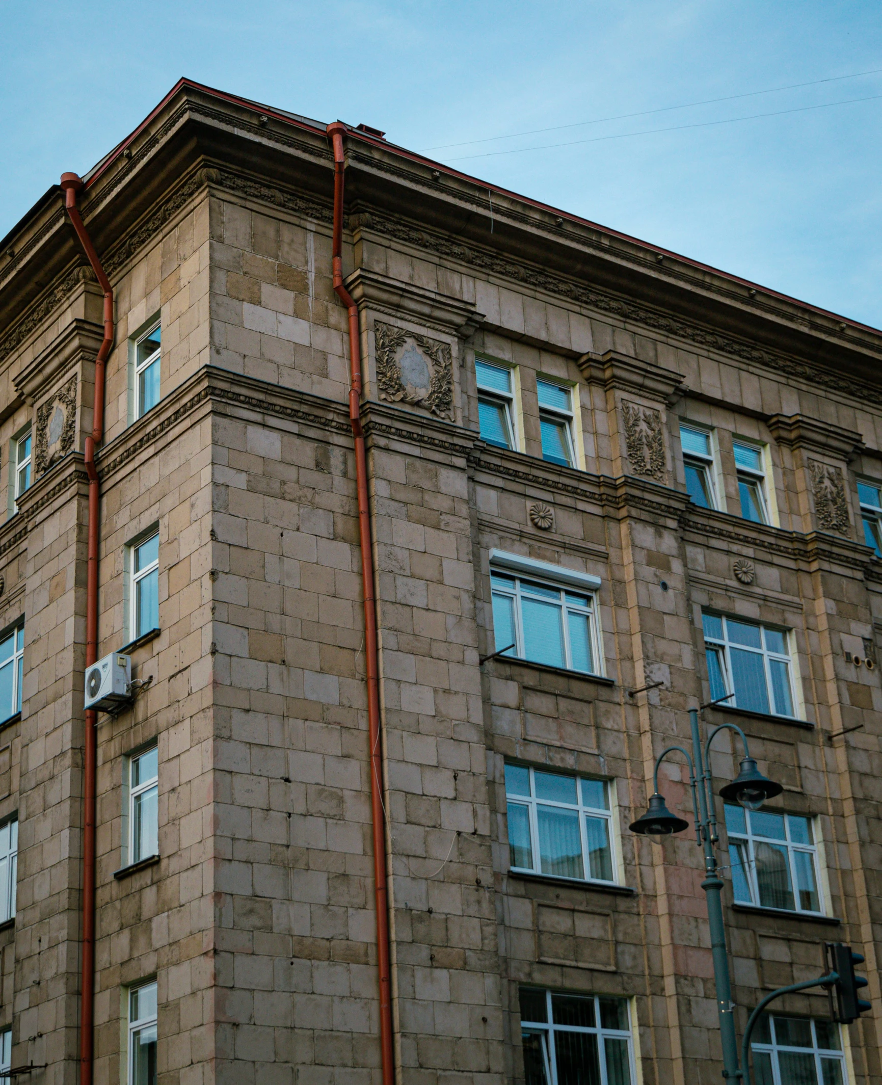 a tall building with lots of windows near a street light