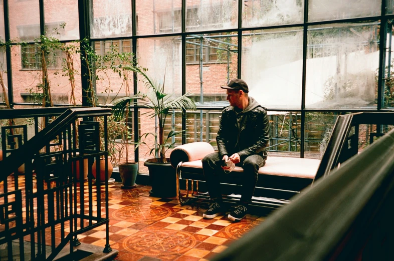 a man sitting on a bench with a panda in the background