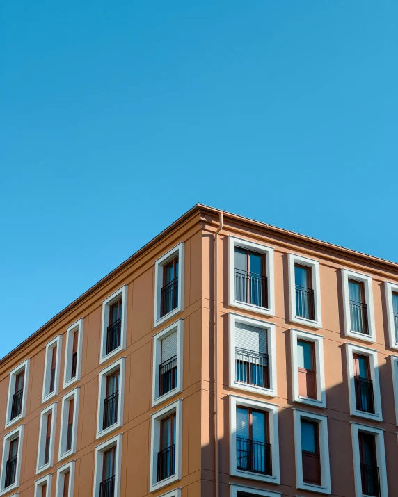 a building with many windows and a sky background