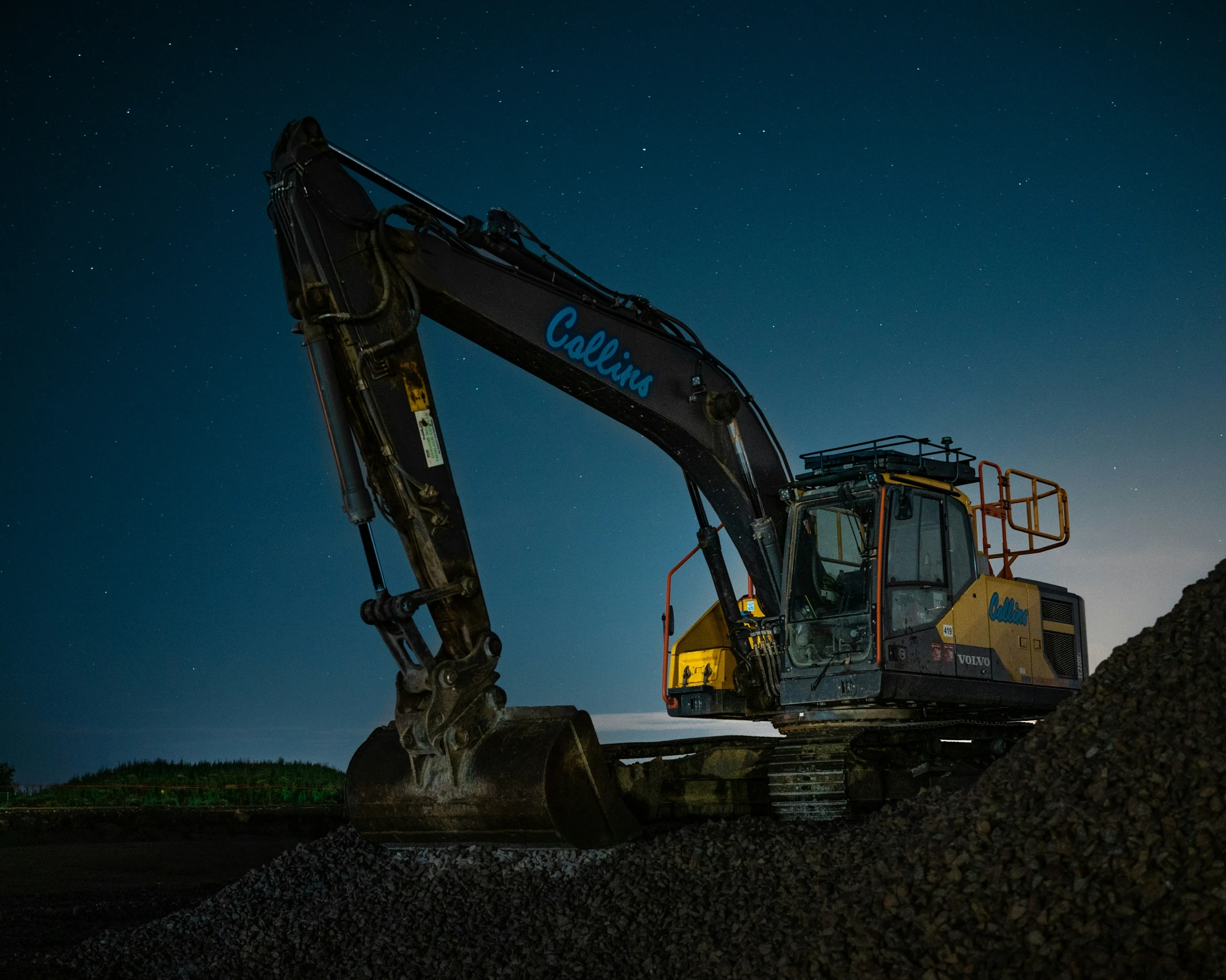 a huge construction machinery digging through some gravel