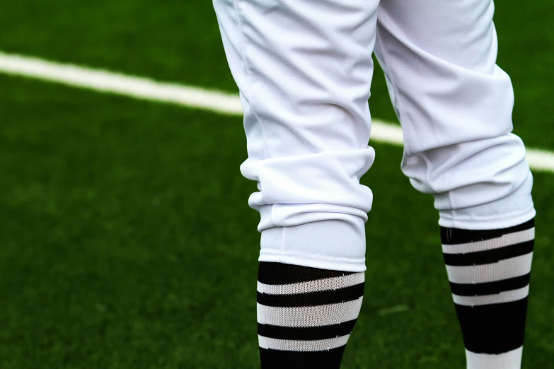 some socks and white pants with black stripes