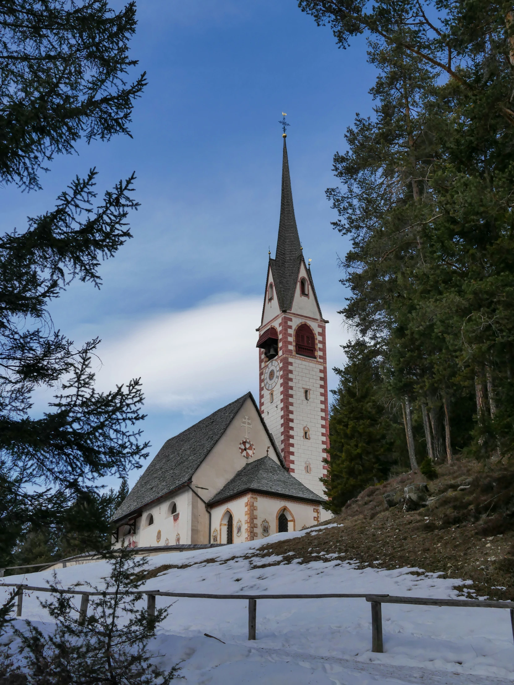 a large church building sitting among some trees