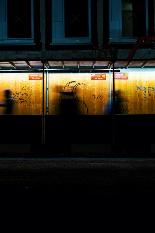 some people sitting on a bench in the dark