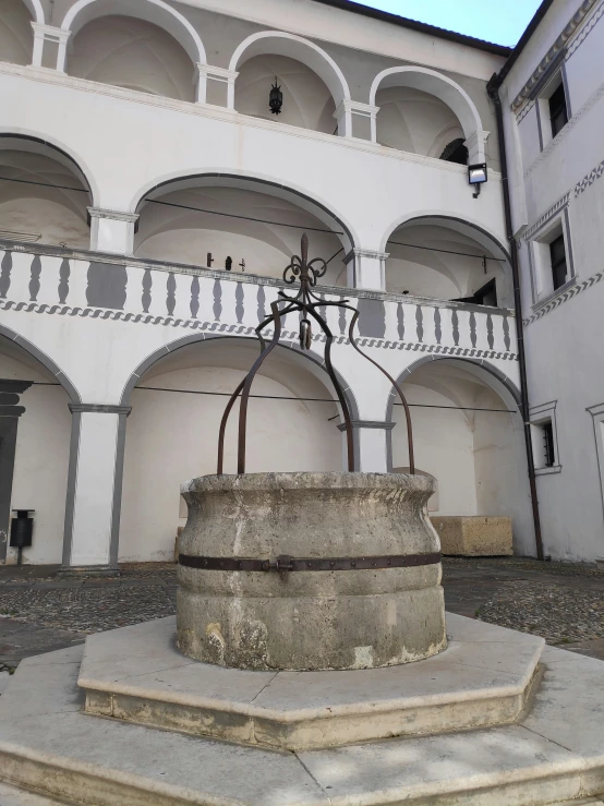 a fountain near a building in a courtyard