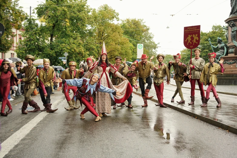 some people in costume dancing on a city street