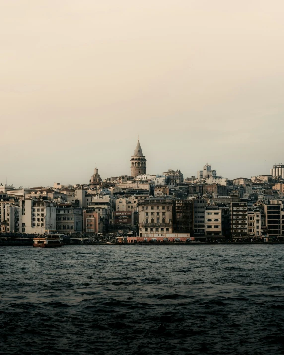 some buildings are sitting at the edge of some water