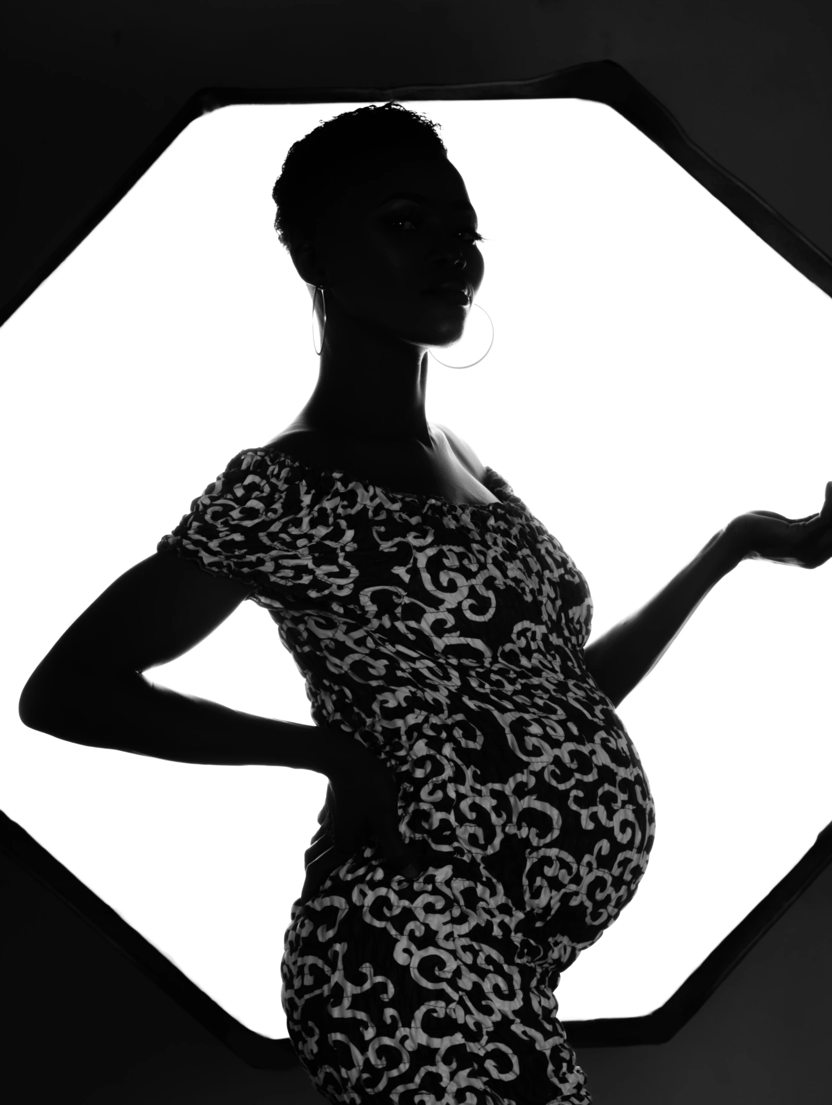 pregnant woman in black and white silhouette with diamond ring