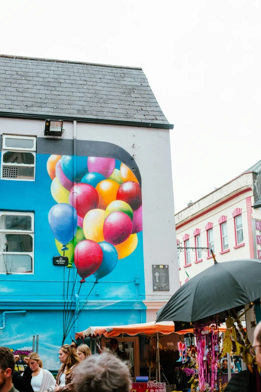 a building has a colorful wall with balloons on it