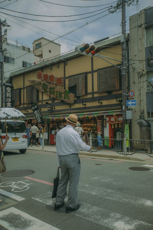 the man stands alone on the street as his luggage is pulled into front