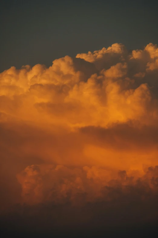 the airplane is flying in the sky during sunrise