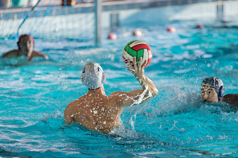 people are playing volleyball in a swimming pool