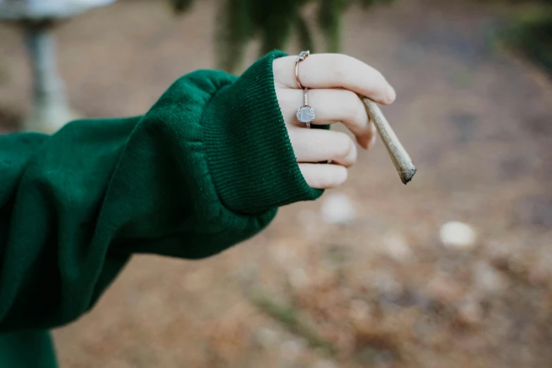 a woman holding onto her tiny cigarette