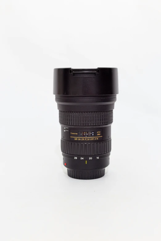 a camera lens cup sitting on top of a white surface