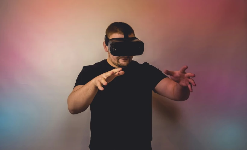 man with black shirt on in the middle of motion using virtual headset