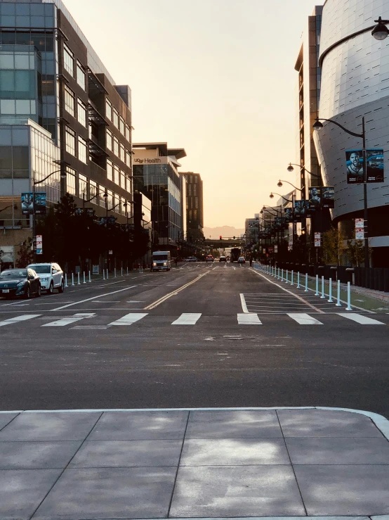 the empty streets are mostly empty as cars drive down them