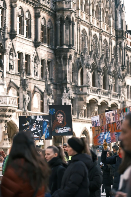 a large group of people on the street with signs