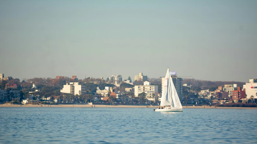 a boat with sails glides on the lake