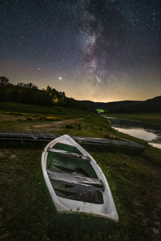 the stars and clouds are reflected in a boat's body