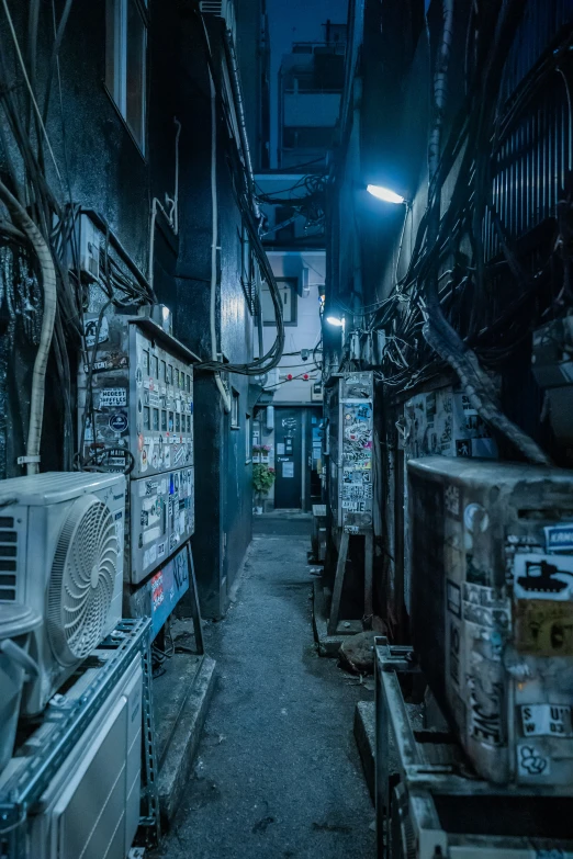 a alley with various appliances, a microwave, and garbage