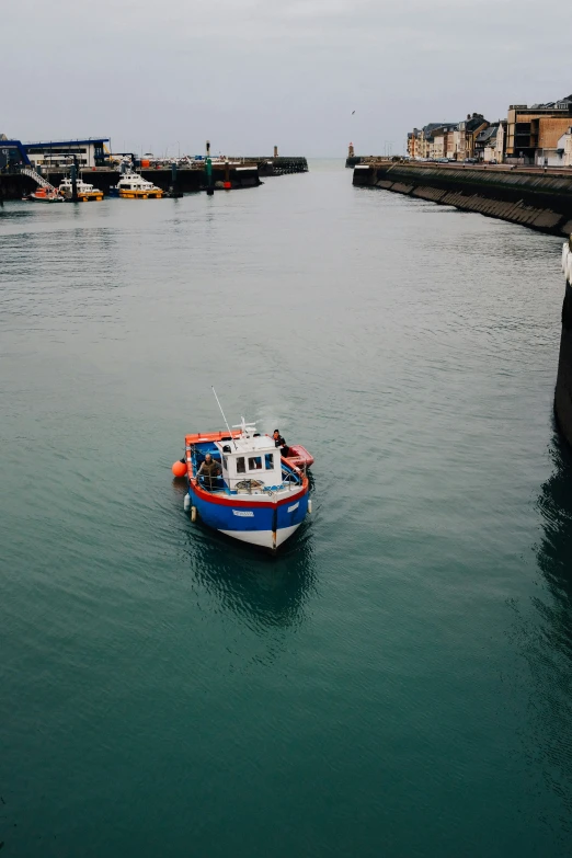 the small boat is heading out to the dock