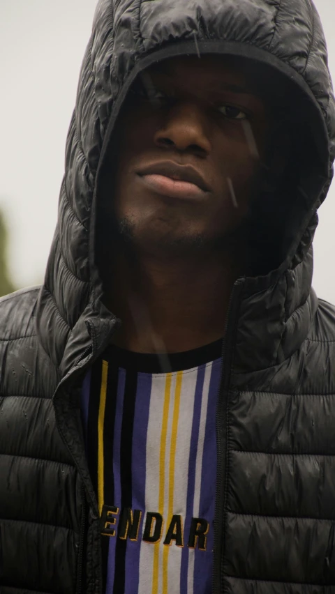 a man wearing a jacket and a hood