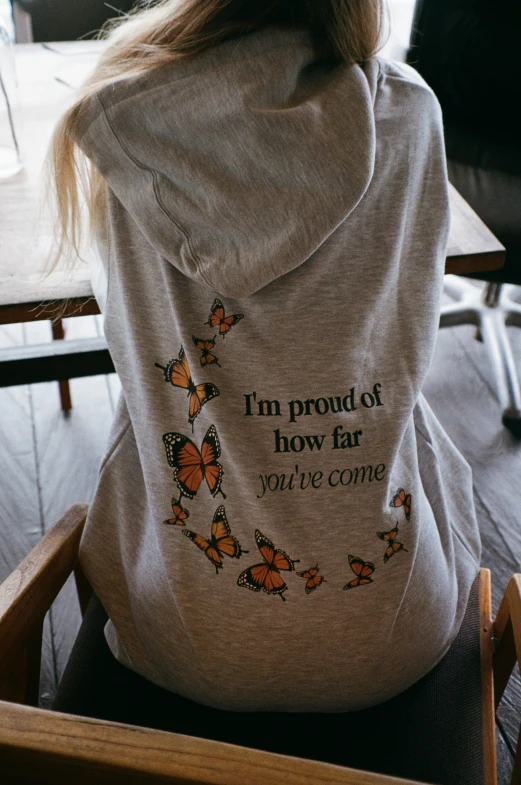 a person wearing a sweatshirt that has the words'i'm proud of how far you can come'on it