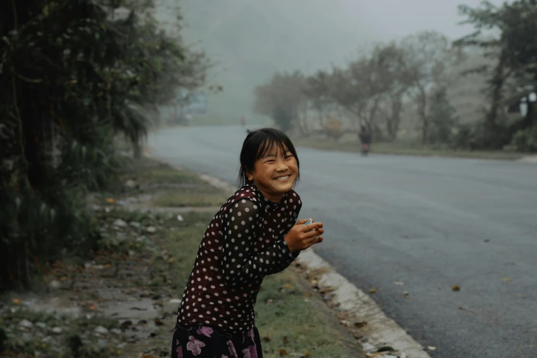 a little girl that is holding soing out and smiling