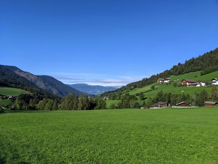 view of green hills on the outskirts of a forested mountain area