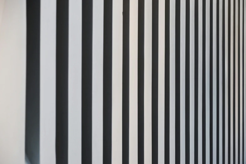 a black and white wall with vertical striped stripes