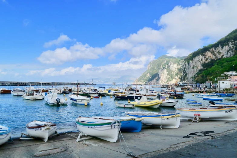 a line up of many boats parked in the water