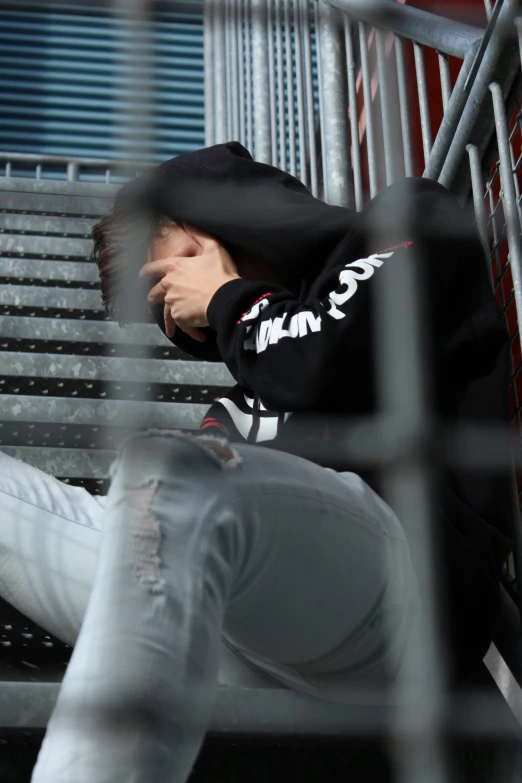 a man sitting on a bench with his head up