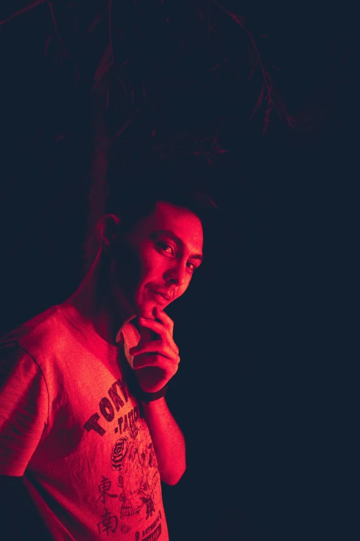 man posing for camera while smoking and looking at his phone